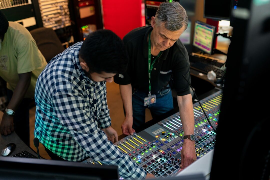 Broadcast technicians reviewing live feeds on a large monitor wall