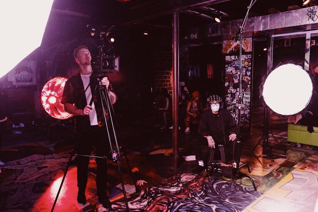 Video production crew setting up lighting on a studio set