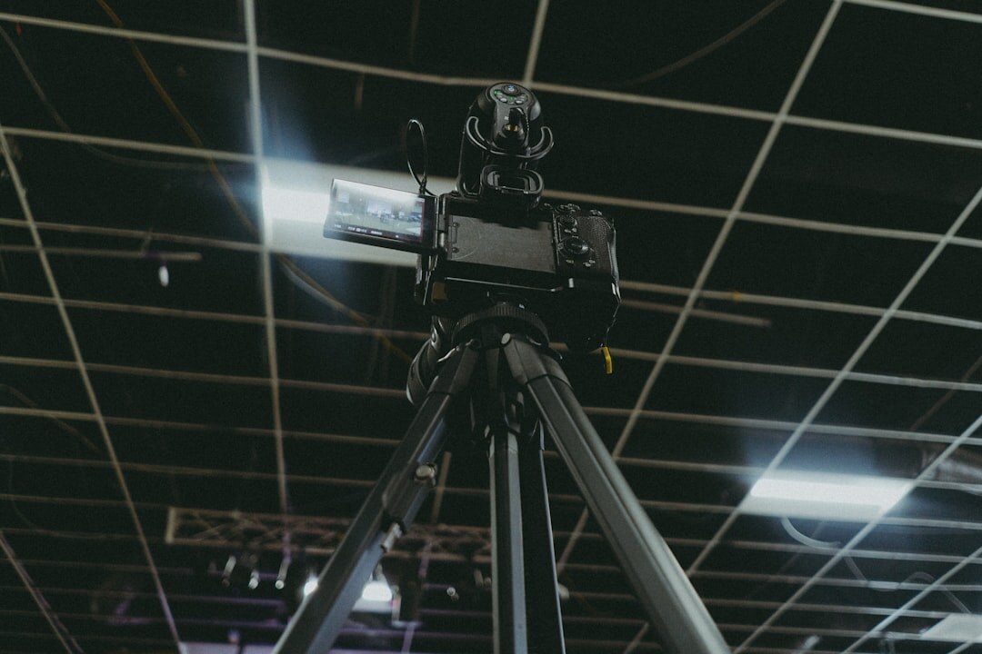 Camera operator trainee practicing with a broadcast camera on a tripod